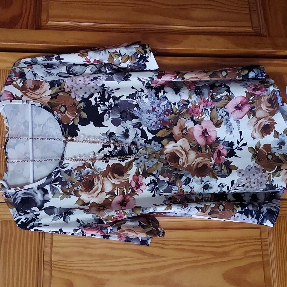 A blouse that includes a pretty necklace.
